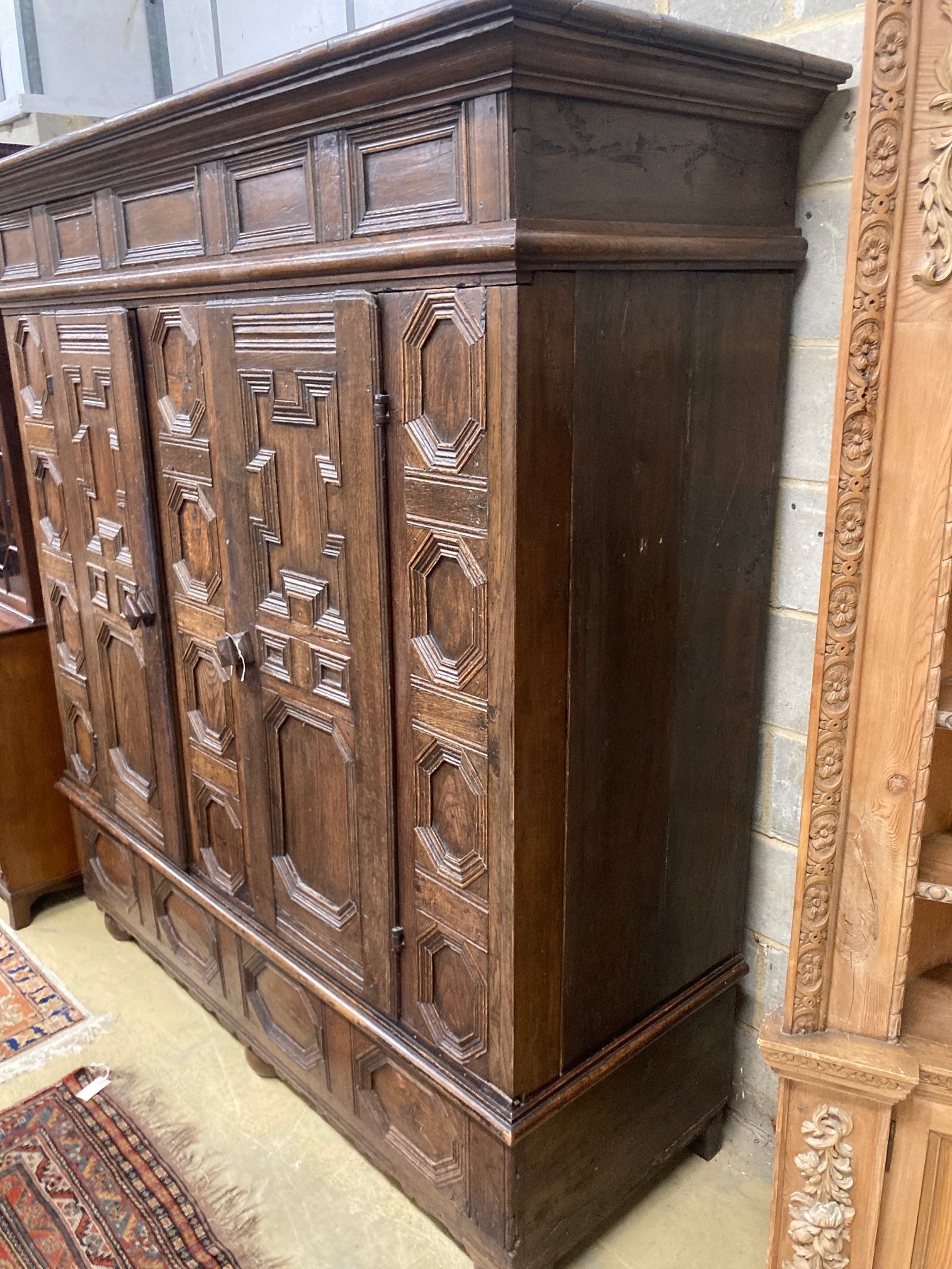 A 17th century and later panelled oak cupboard, length 194cm, depth 70cm, height 198cm